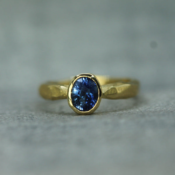 oval blue sapphire set in 18k yellow gold 