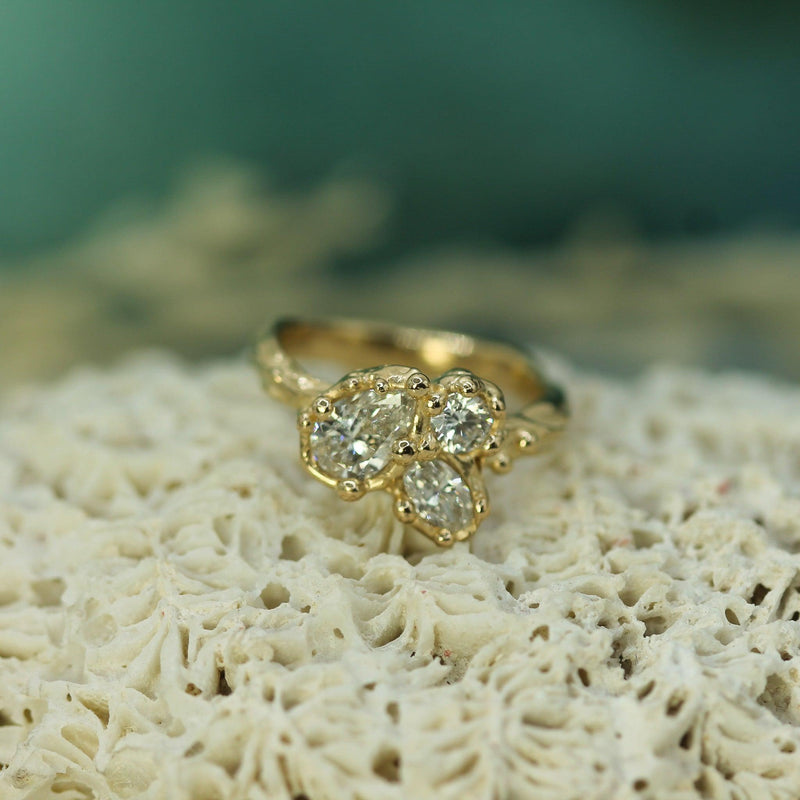 Gold ring with diamonds on a textured surface