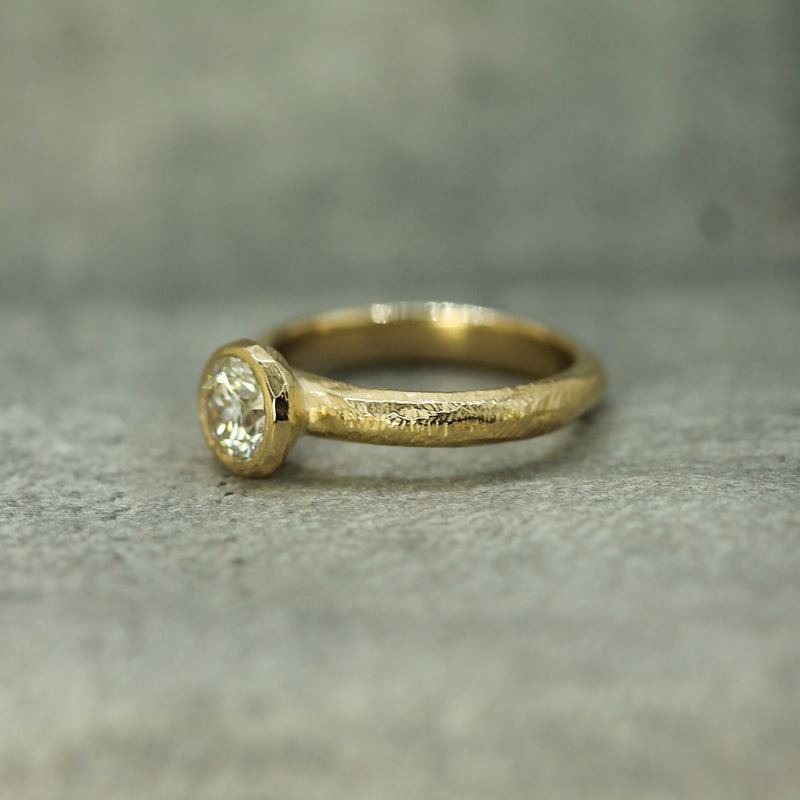 14k yellow gold engagement ring showing textured band 