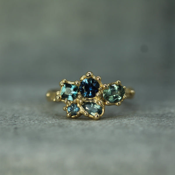 14k yellow gold blue tones of sapphires set in a cluster ring 
