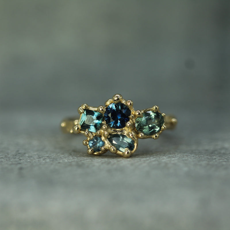 14k yellow gold blue tones of sapphires set in a cluster ring 
