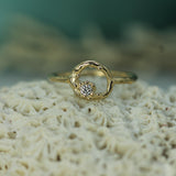 Gold ring with a diamond on a piece of coral