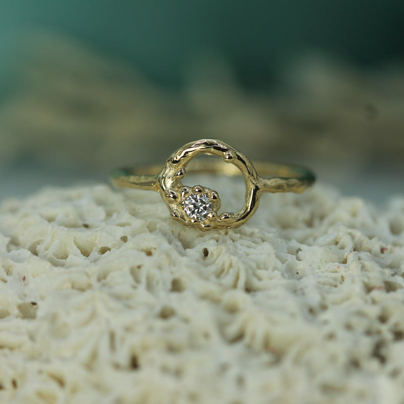 Gold ring with a diamond on a piece of coral