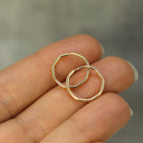 angular gold hoops on hand 