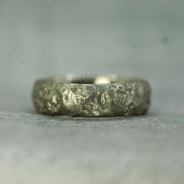 unearthed textured wedding band shown in 14k white gold 