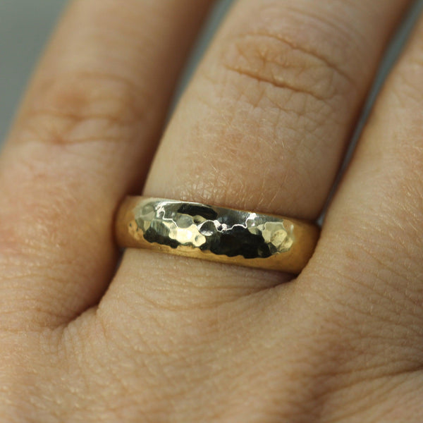 hammered gold wedding band on hand 