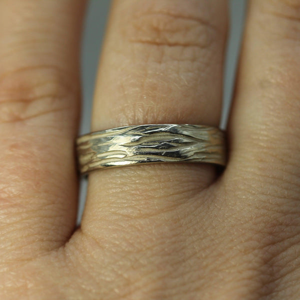 white gold cathedral grove wedding band on hand 