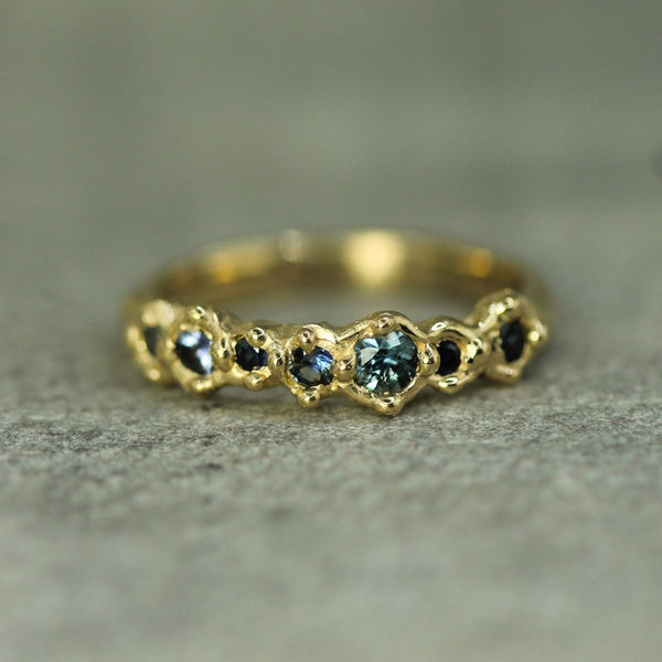 14k yellow gold band with blue sapphires