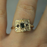 gold sapphire ring on hand 