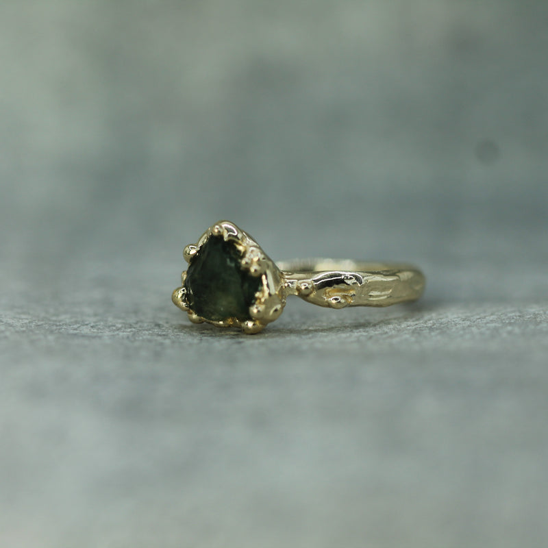 hand carved textured yellow gold ring with raw sapphire 