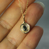 10k yellow gold sapphire pendant on hand 