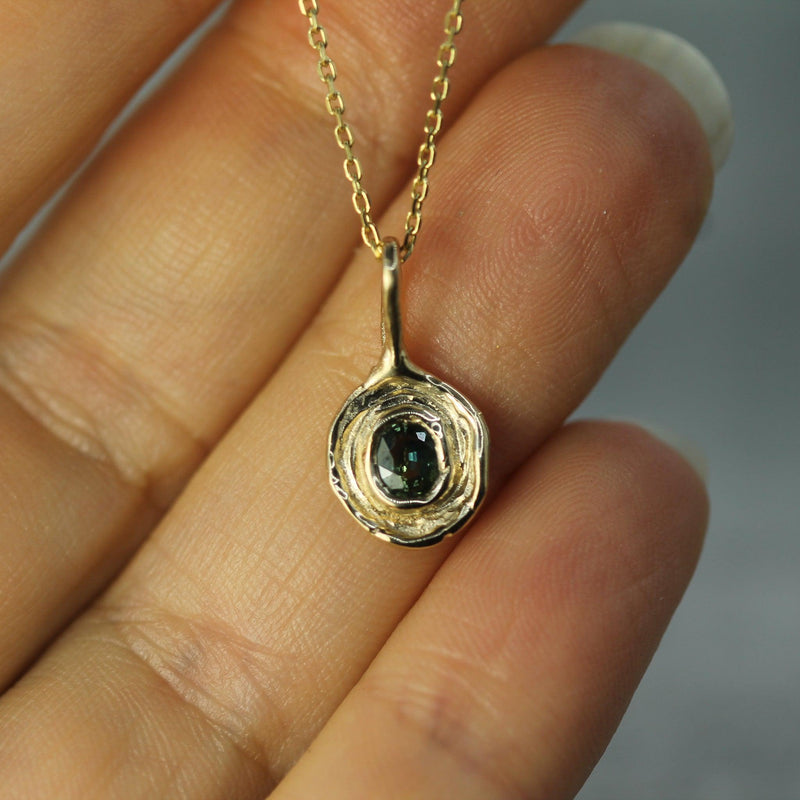 10k yellow gold sapphire pendant on hand 