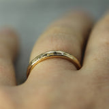 hammered 14k yellow gold band on finger 
