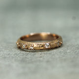 14k rose gold wedding band with 5 staggered diamonds 