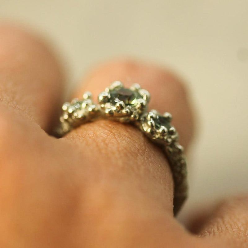 white gold bubbly ring on hand showing the low profile design 