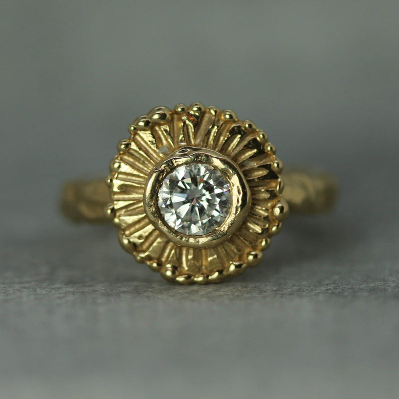 .42ct round diamond set in a handcarved sun inspired setting in yellow gold 