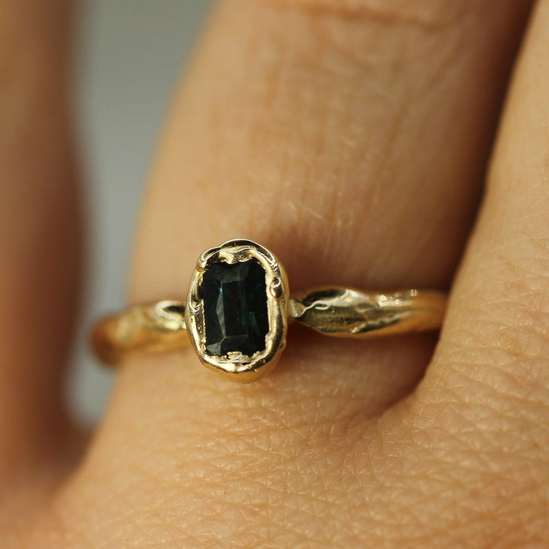 dark blue sapphire ring on hand 