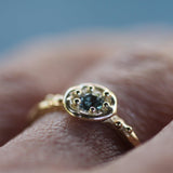 Ocean Blue Sapphire Tidal Halo Ring on women's hand -Emma Glover Designs